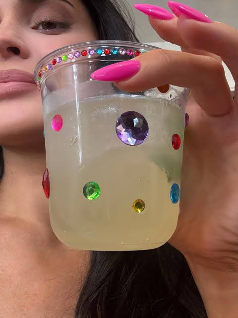 A drink decorated with colorful gems
